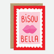 French-inspired Bisou Bella greeting card featuring pink lips and playful typography on premium cardstock with a blank interior and kraft envelope.