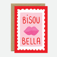 French-inspired Bisou Bella greeting card featuring pink lips and playful typography on premium cardstock with a blank interior and kraft envelope.