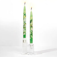 Set of two decorative taper candles inspired by Van Gogh Still Life Vase with Pink Roses artwork featuring painterly green floral designs and handcrafted flat candle style.