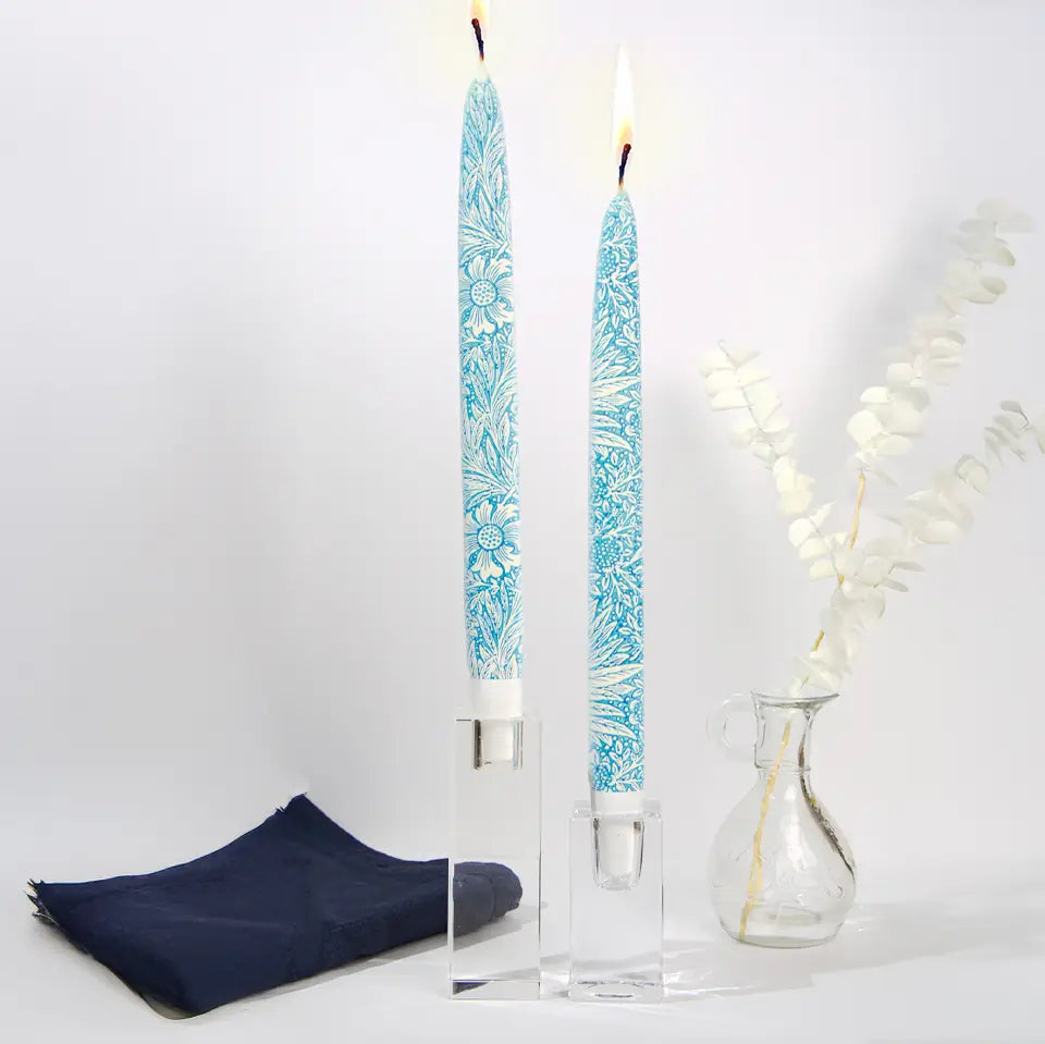 Set of two William Morris Blue Marigold decorative taper candles featuring blue botanical floral artwork and handcrafted flat candle design.