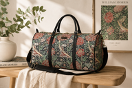 William Morris tapestry weekender duffel bag featuring The Cray floral pattern and faux leather handles