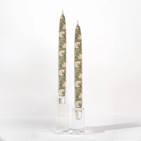 Set of two William Morris Pimpernel decorative taper candles featuring botanical floral artwork in soft sage green, blush, and cream tones.