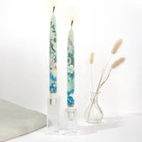 Set of two decorative taper candles inspired by Paul Cézanne Flowers in a Rococo Vase artwork featuring blue and green painterly floral designs.