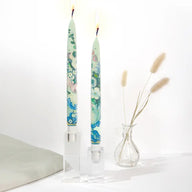 Set of two decorative taper candles inspired by Paul Cézanne Flowers in a Rococo Vase artwork featuring blue and green painterly floral designs.
