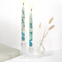 Set of two decorative taper candles inspired by Paul Cézanne Flowers in a Rococo Vase artwork featuring blue and green painterly floral designs.