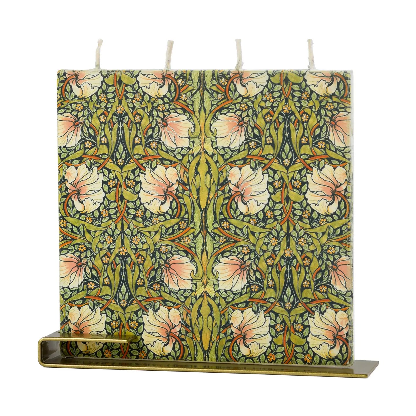 Square William Morris Pimpernel flat decorative candle featuring intricate botanical floral artwork in green, blush, and gold tones with brass display stand.
